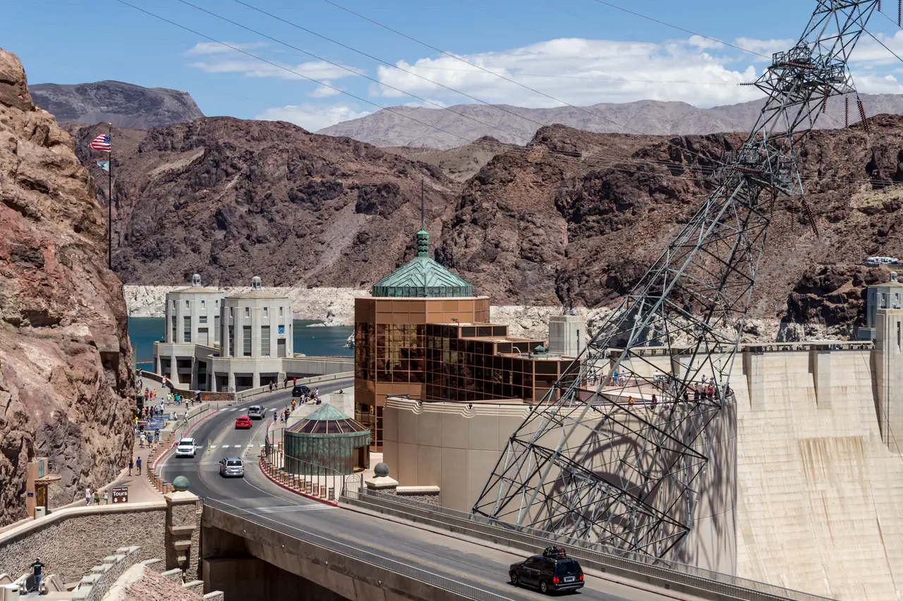 Hoover Dam curving across Black Canyon on the Colorado River with the intake towers and Lake Mead behind