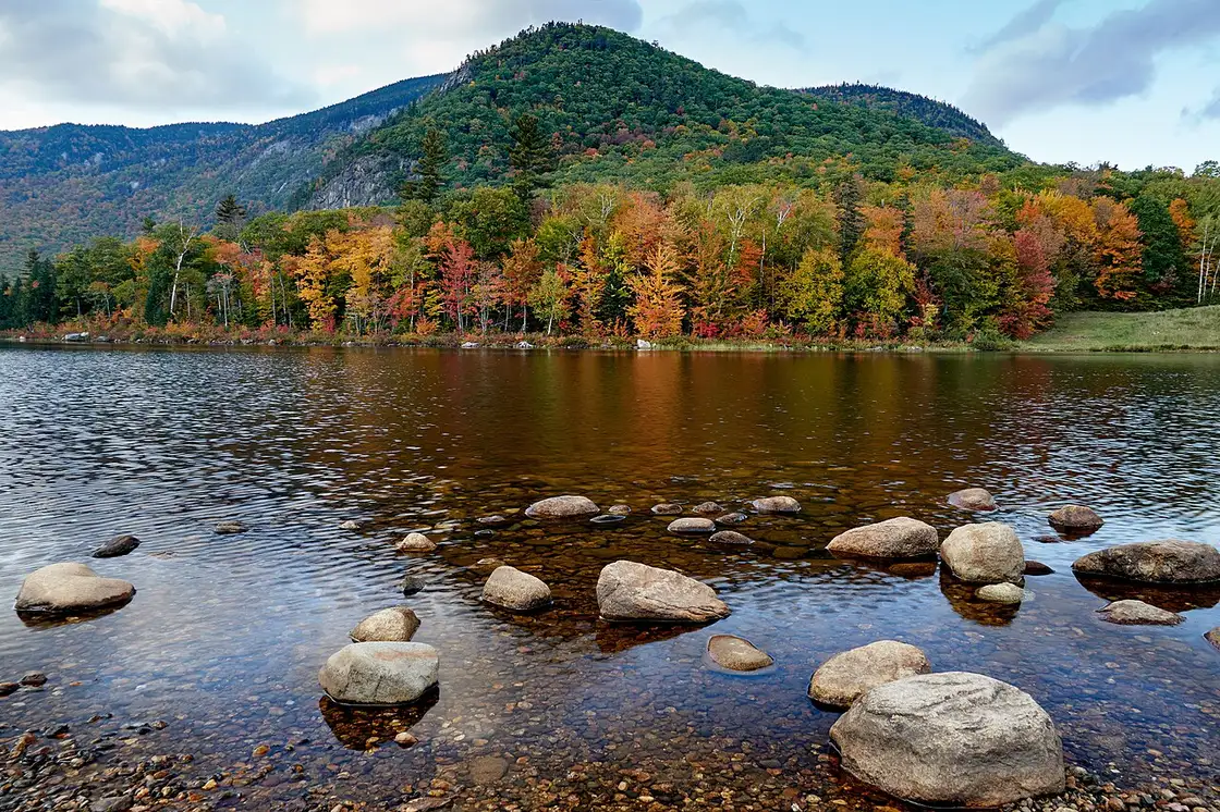 Autumn color reflected on Basin Brook Reservoir in New Hampshire