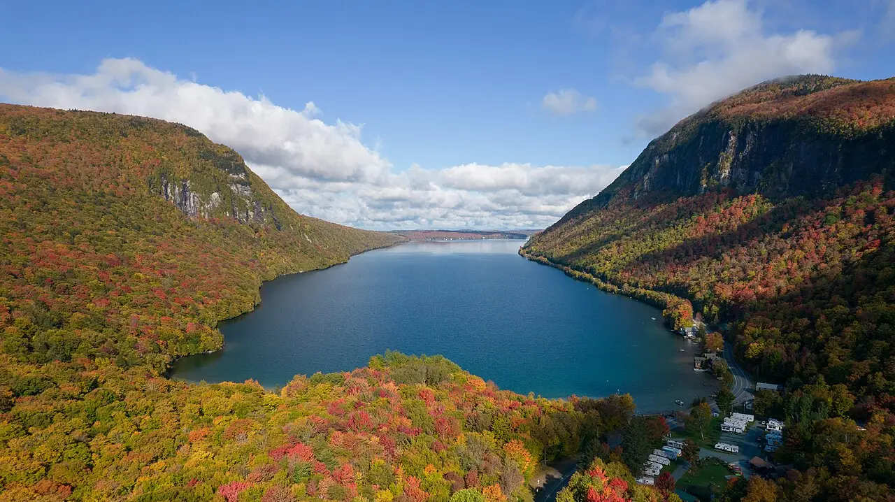 Orange and red fall foliage reflected on Lake Willoughby in Vermont's Northeast Kingdom