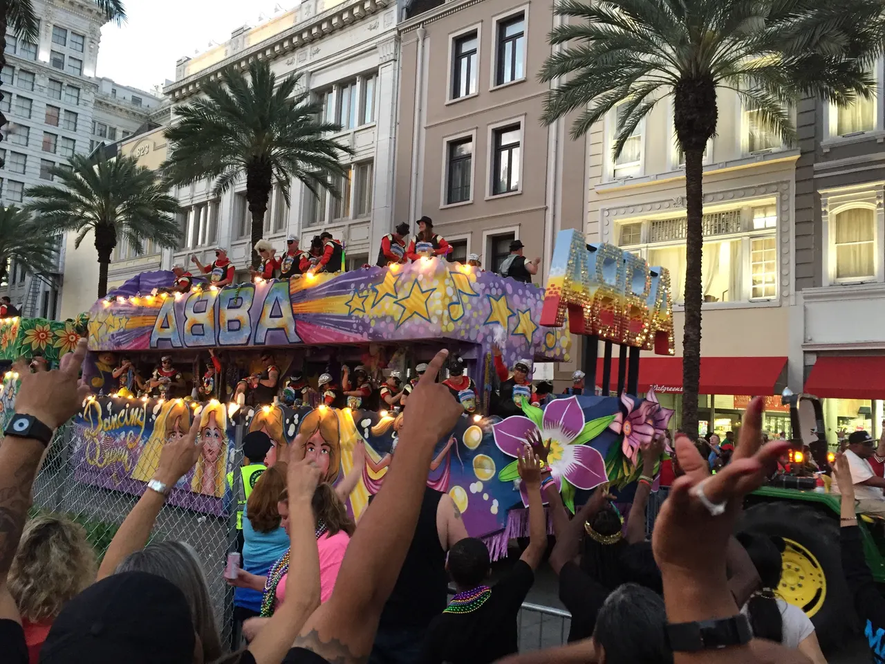 A decorated Mardi Gras parade float moving along Canal Street in New Orleans