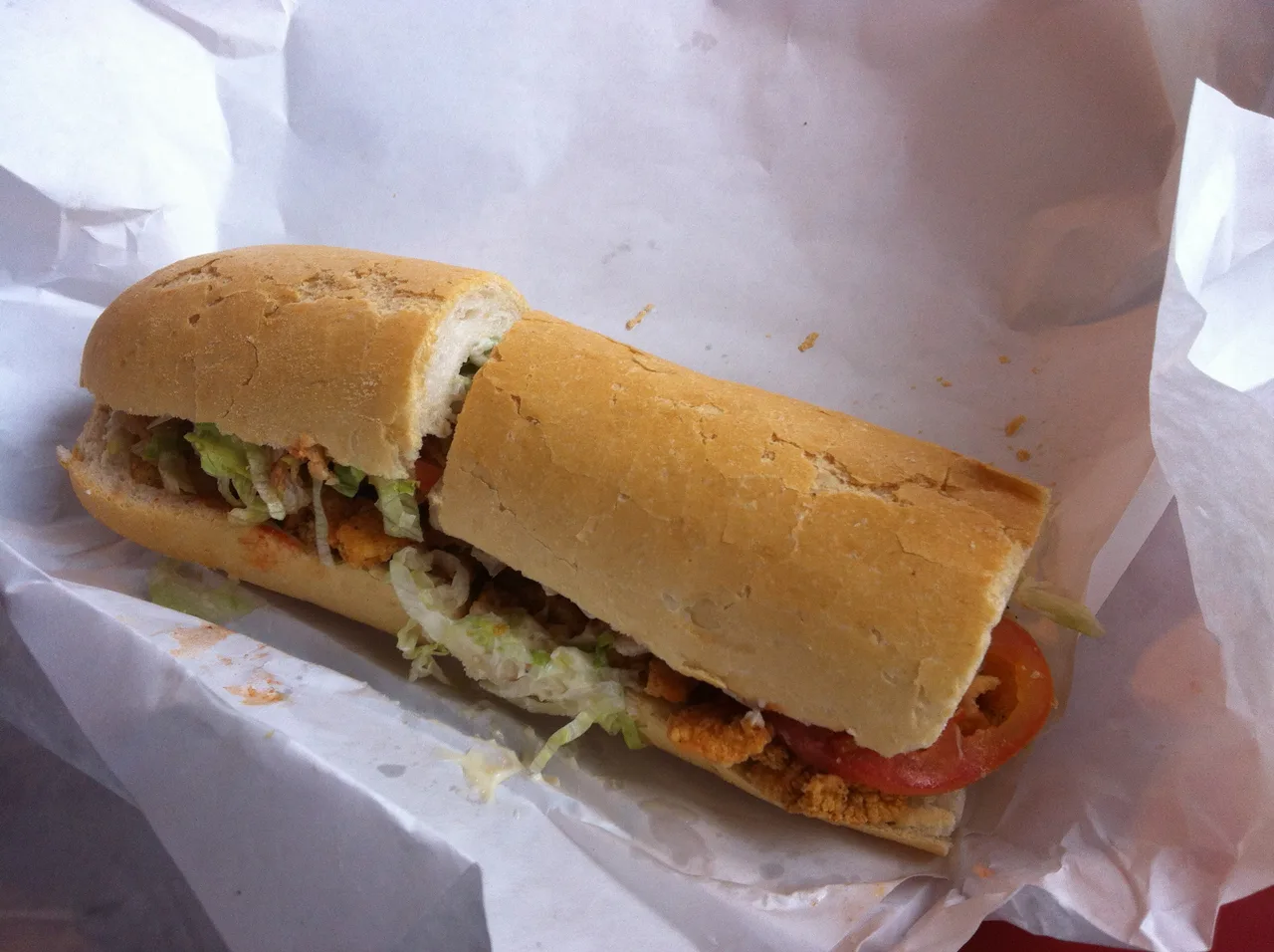 A dressed shrimp po-boy on French bread at a New Orleans sandwich shop