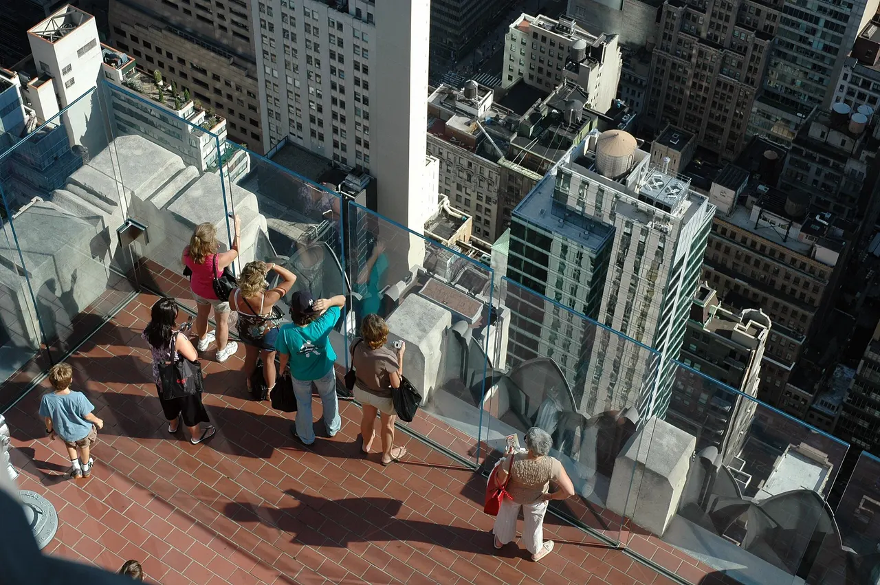 Open-air observation deck at Top of the Rock with visitors along the railing
