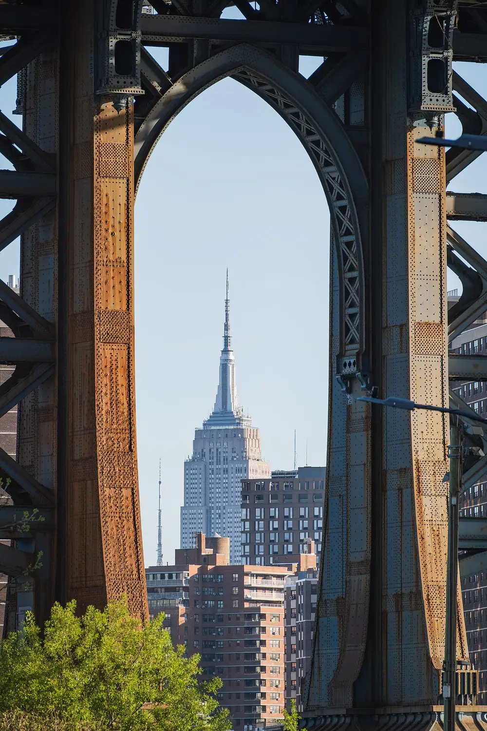 The Empire State Building framed by the arch of the Manhattan Bridge seen from Washington Street in DUMBO
