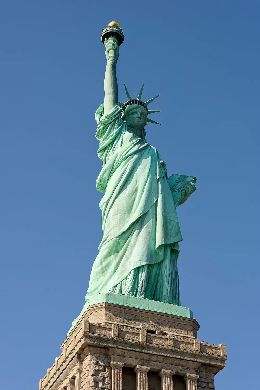 The Statue of Liberty on Liberty Island seen from the water on a clear day