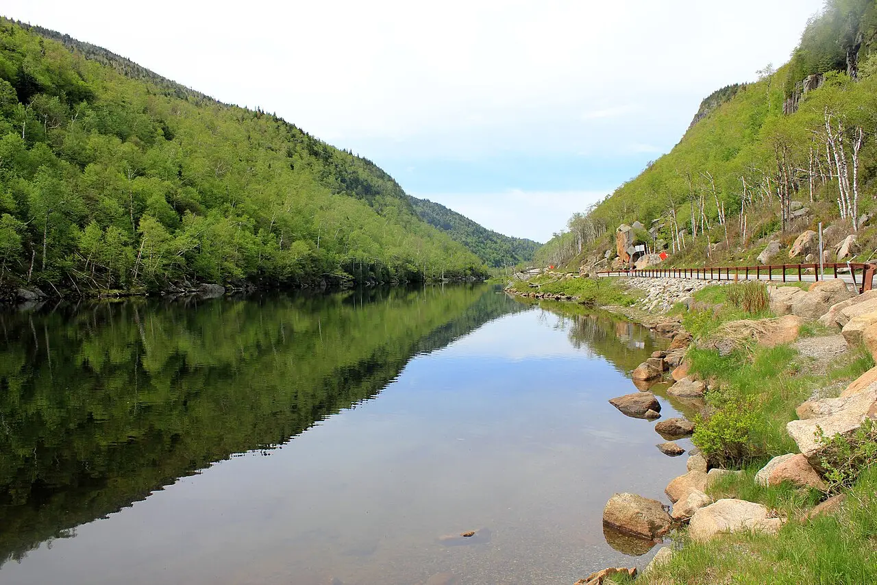 A still lake ringed by forested mountains in the Adirondacks of upstate New York