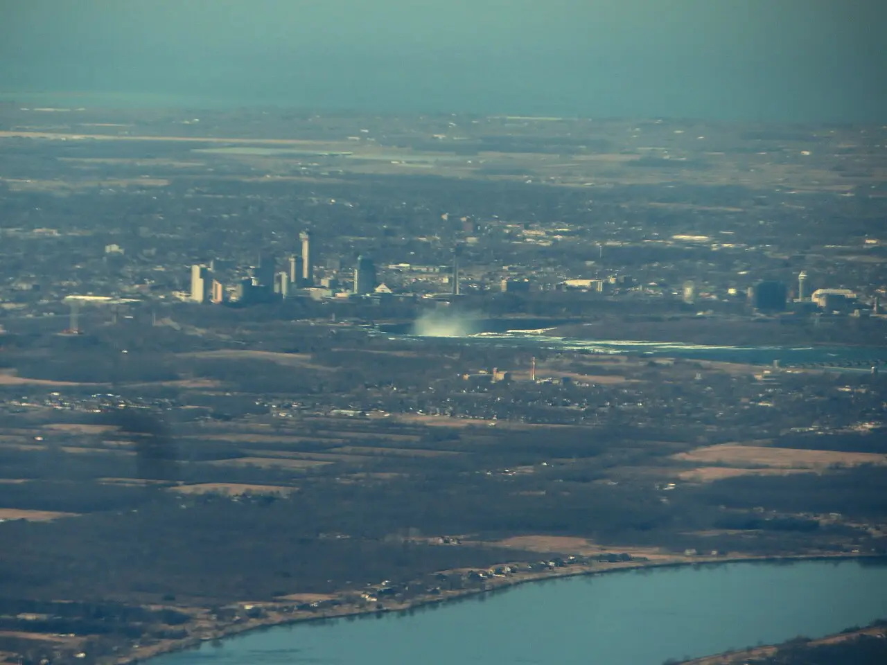 Aerial view of Niagara Falls on the New York and Ontario border with mist rising from the base