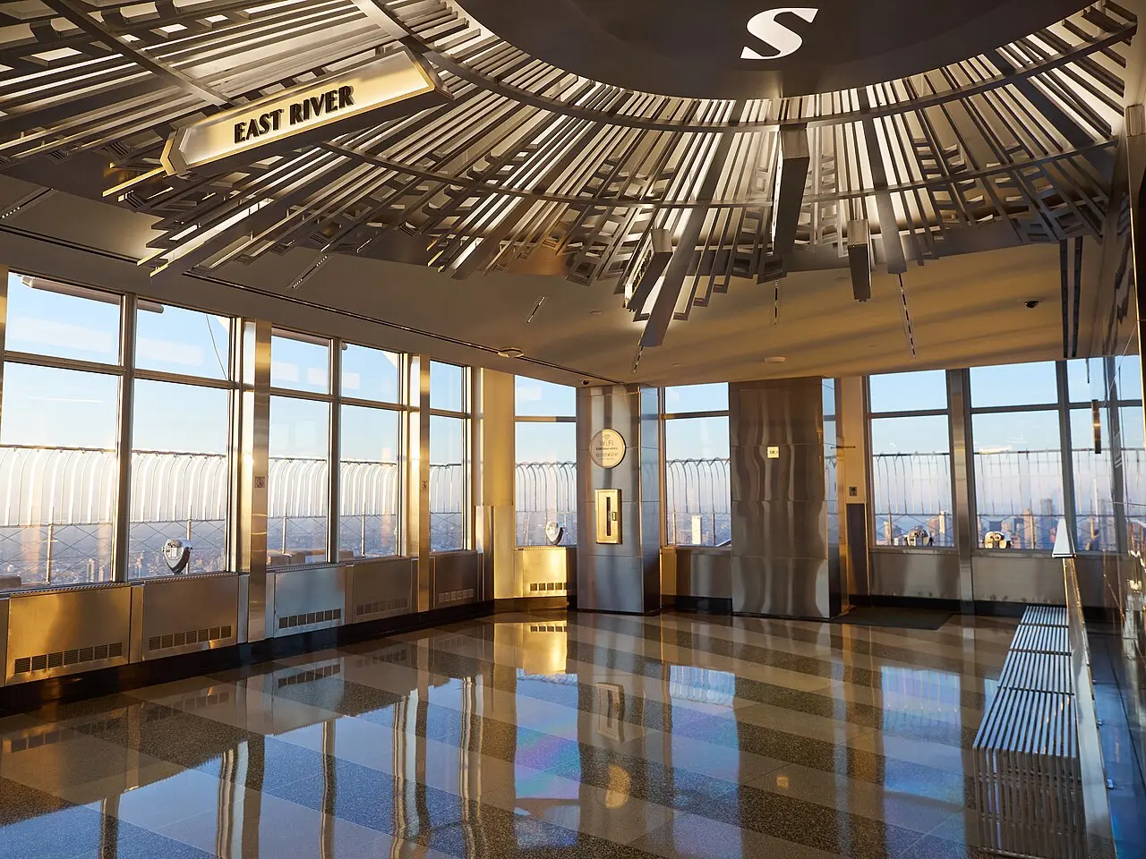 Glass-walled indoor viewing area on the Empire State Building's 86th floor, just before the doors to the open-air deck