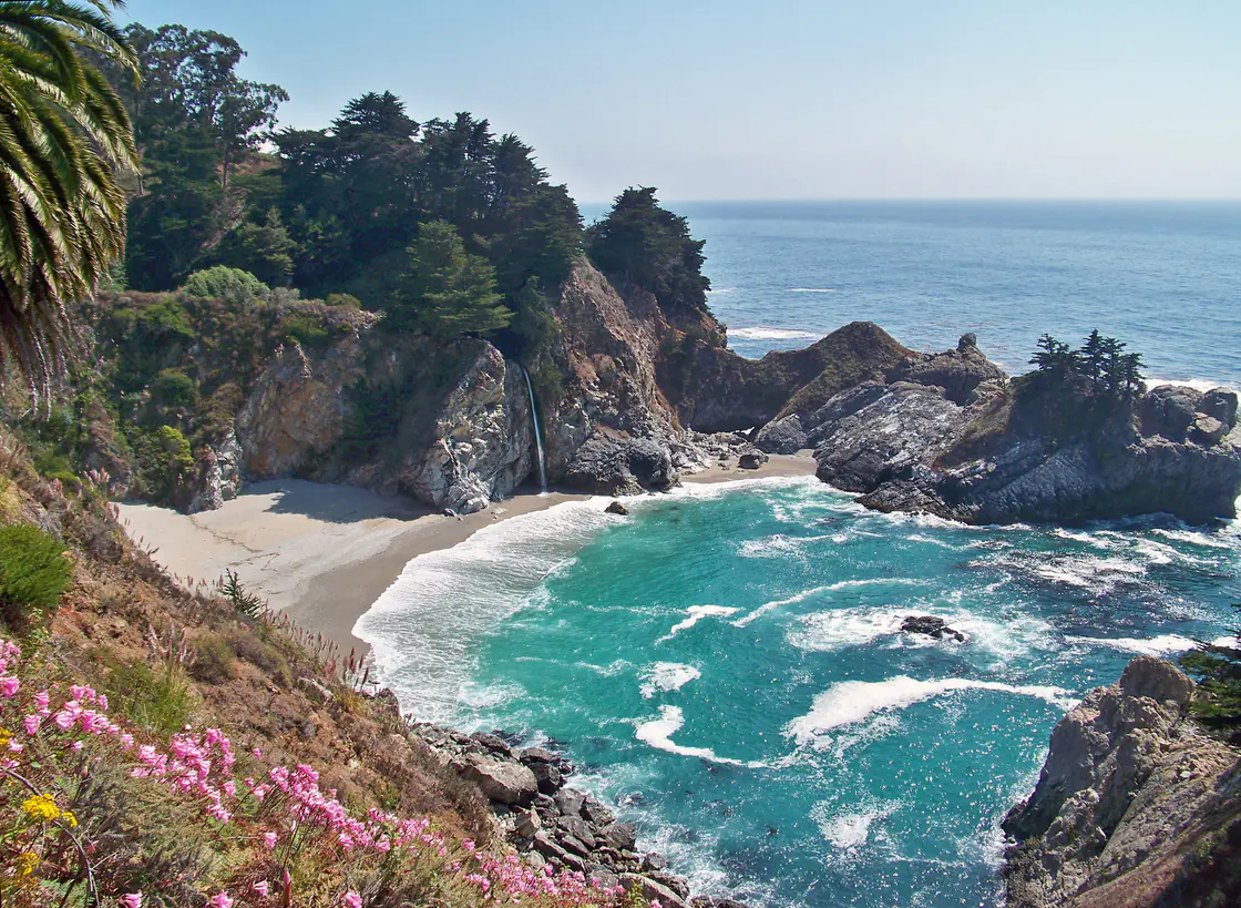 McWay Falls dropping onto the sand of a turquoise cove in Big Sur