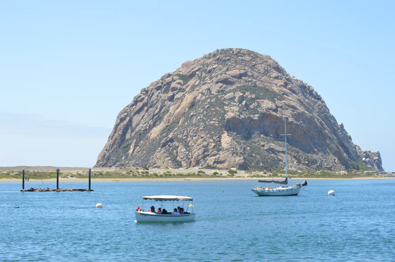 Morro Rock rising above the water and boats of Morro Bay harbor