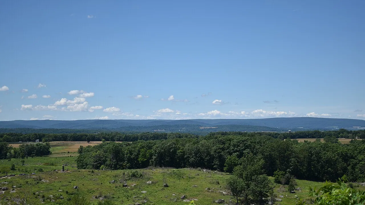 View west from Little Round Top over the Gettysburg battlefield with monuments and open fields