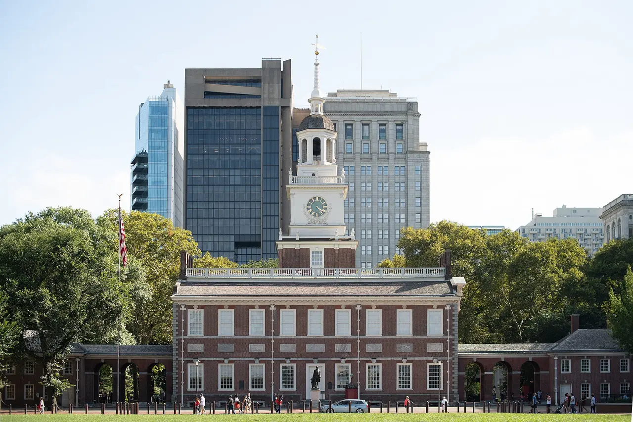 The brick facade and clock tower of Independence Hall on Chestnut Street in Philadelphia