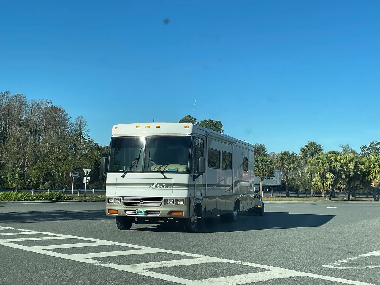 A large Class A motorhome parked on a paved lot