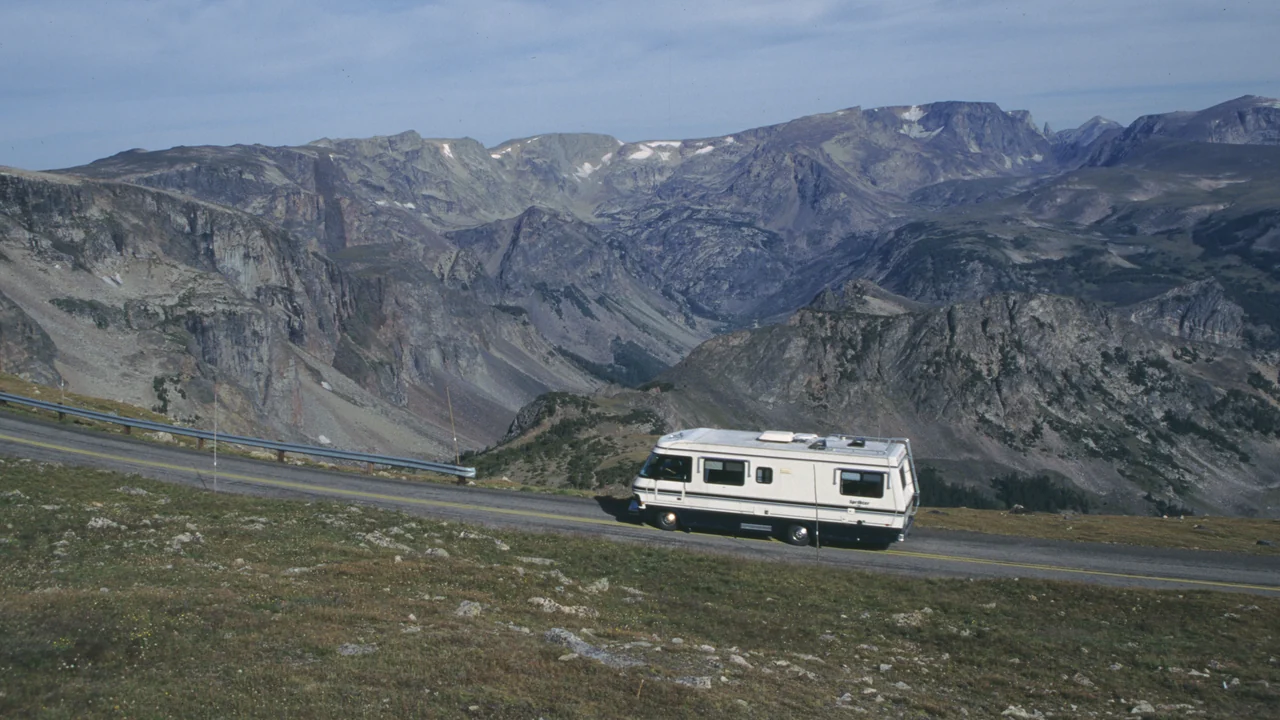 A motorhome driving the Beartooth Highway through open mountain country
