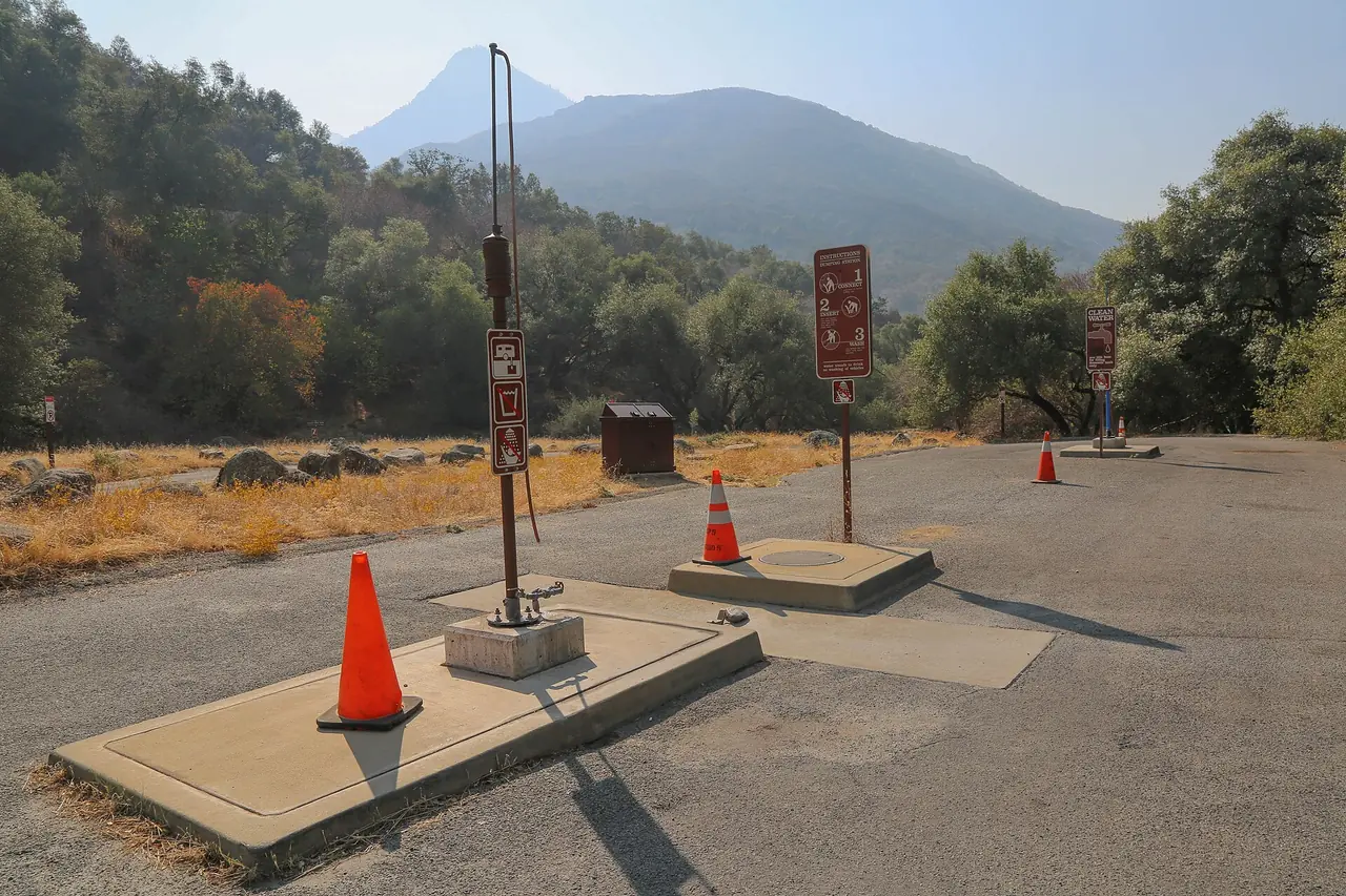 An RV dump station with a potable water line at a campground