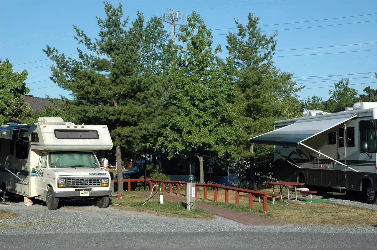 RVs on paved sites with electrical and water hookups at a private campground