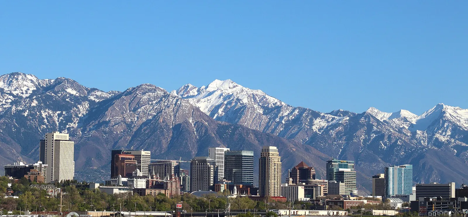 Downtown Salt Lake City skyline with the snow-capped Wasatch Range rising directly behind the towers