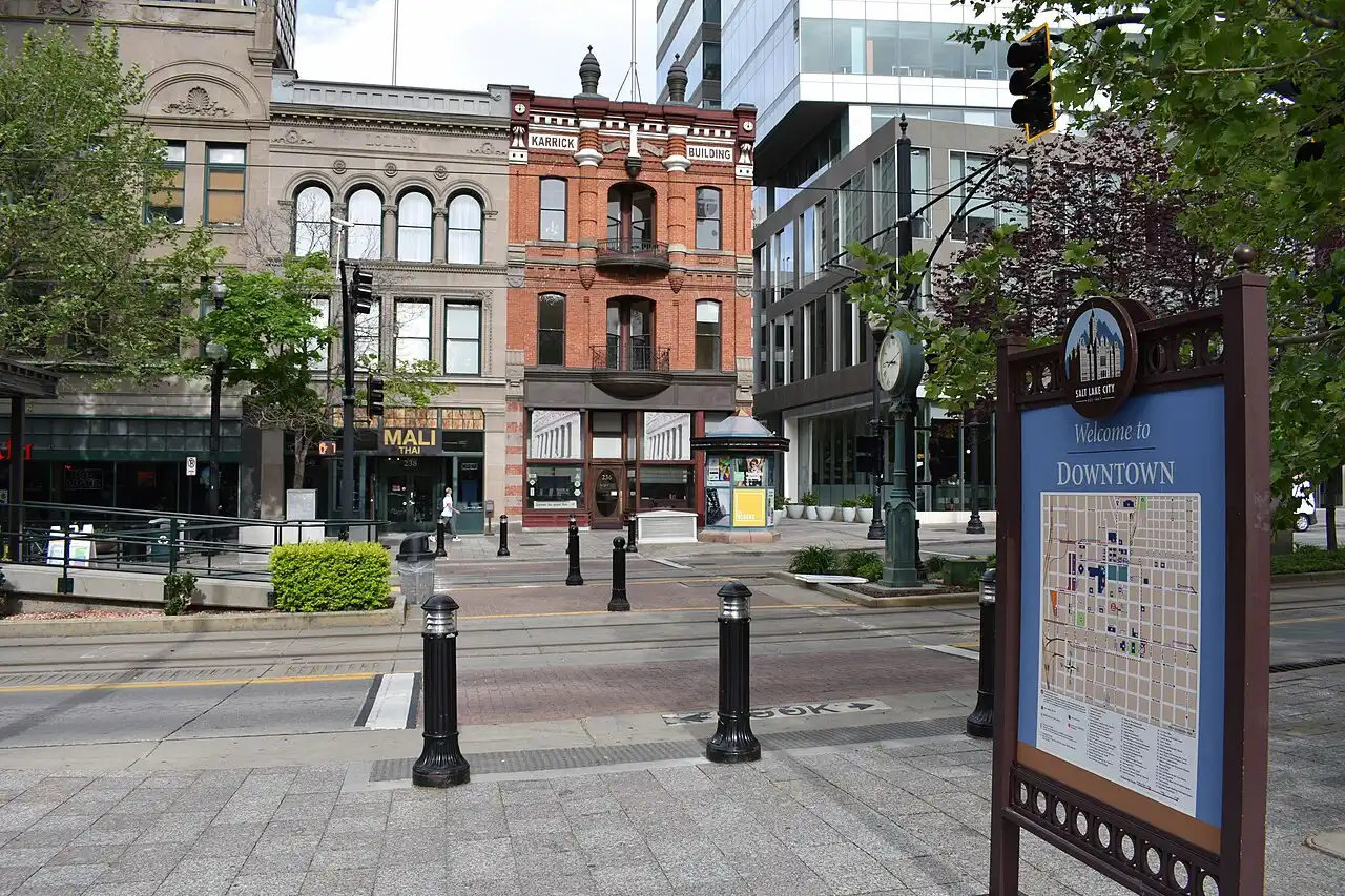 Historic brick buildings and a welcome sign along Main Street in downtown Salt Lake City