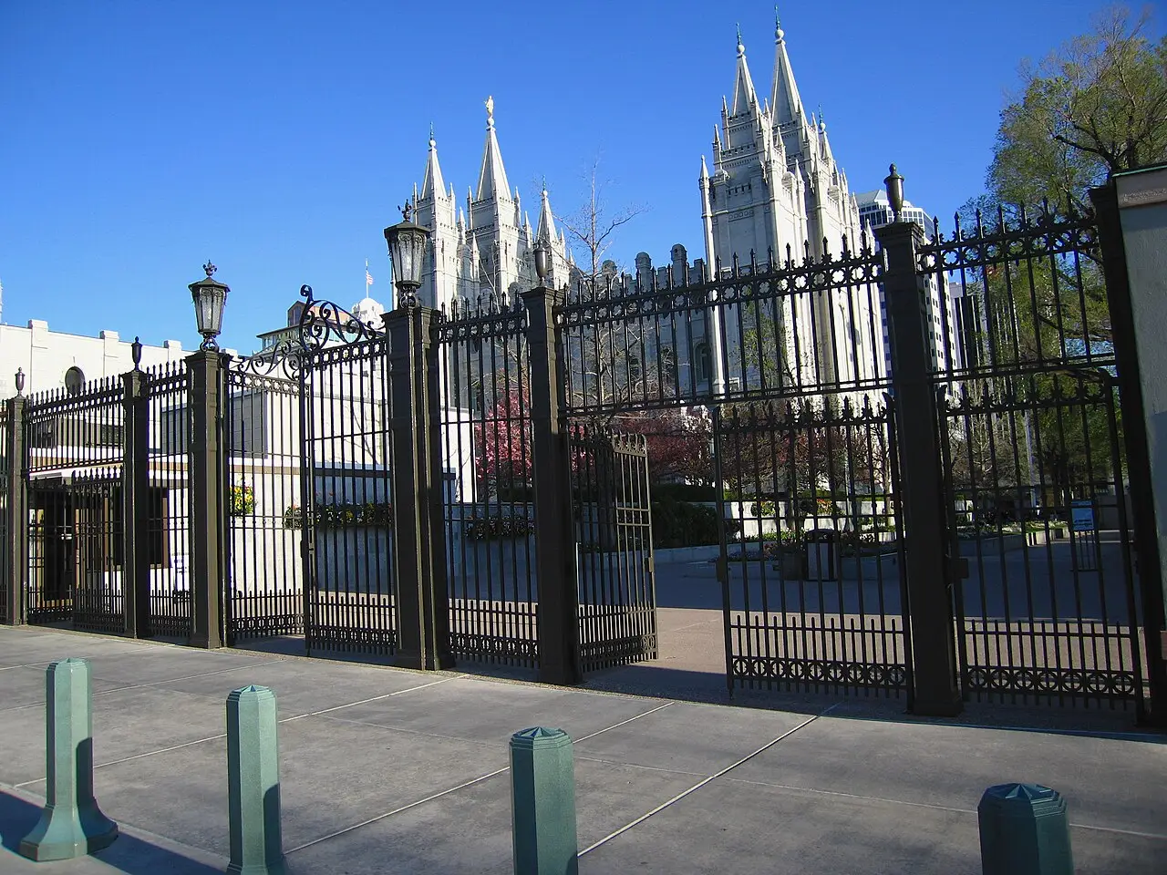 Wrought-iron gates at the north entrance of Temple Square with the spires of the Salt Lake Temple visible beyond