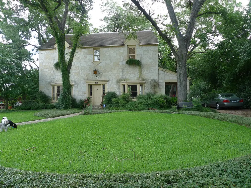 Victorian houses with wide porches on a shaded street in the King William Historic District of San Antonio