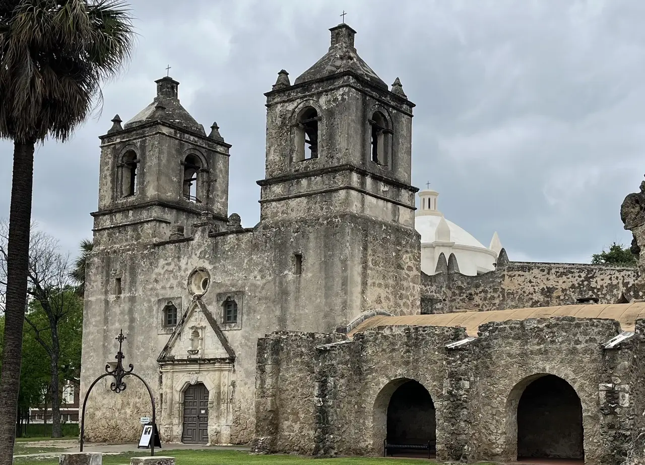 The twin-towered stone facade of Mission Concepcion in San Antonio