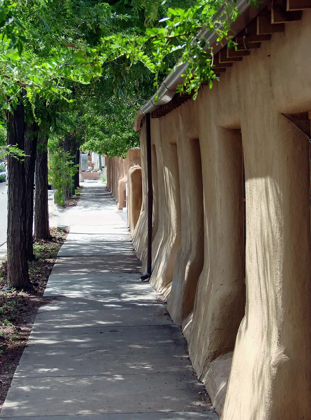 Tree-shaded adobe walkway in Santa Fe