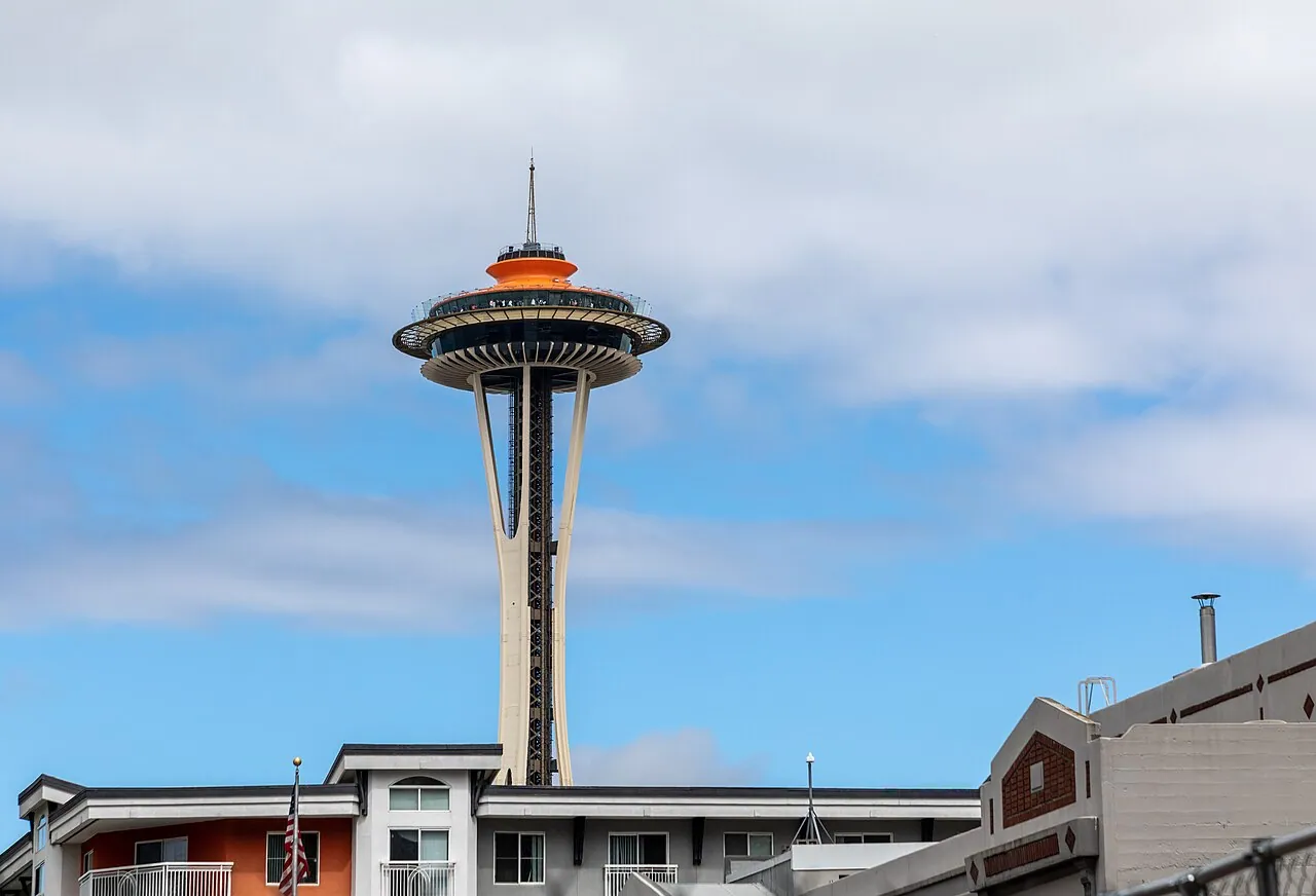 The Space Needle rising above Seattle Center against a blue sky