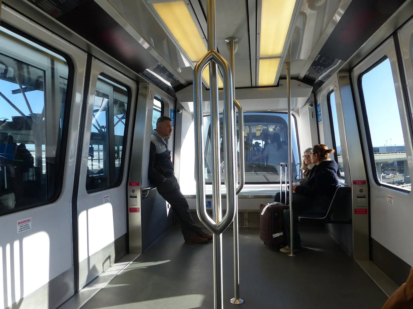 A driverless SFO AirTrain car on its elevated guideway between terminals