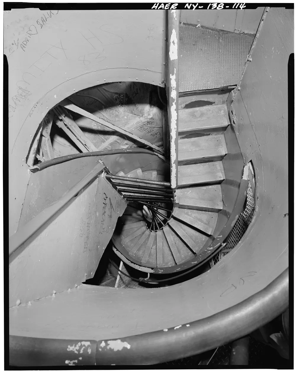 Looking down the tight helical stairwell inside the Statue of Liberty from the crown platform