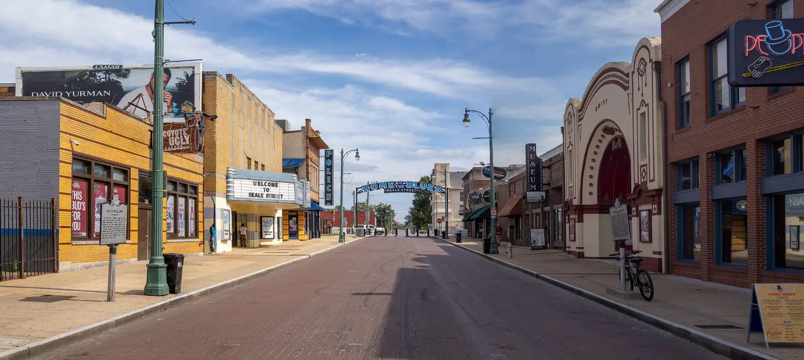 The Welcome to Beale Street sign and the Home of the Blues arch over an empty Beale Street in Memphis