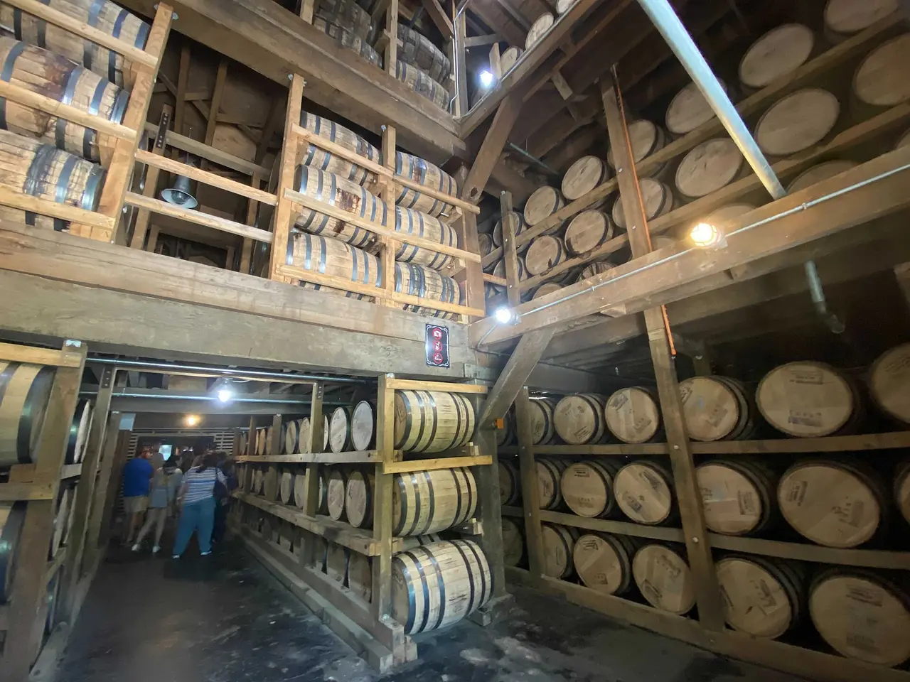 Rows of whiskey barrels stacked on wooden racks inside a Jack Daniel's barrel house in Lynchburg