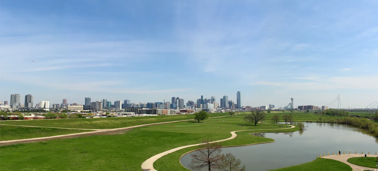 The Dallas skyline reflected in the Trinity River at dusk
