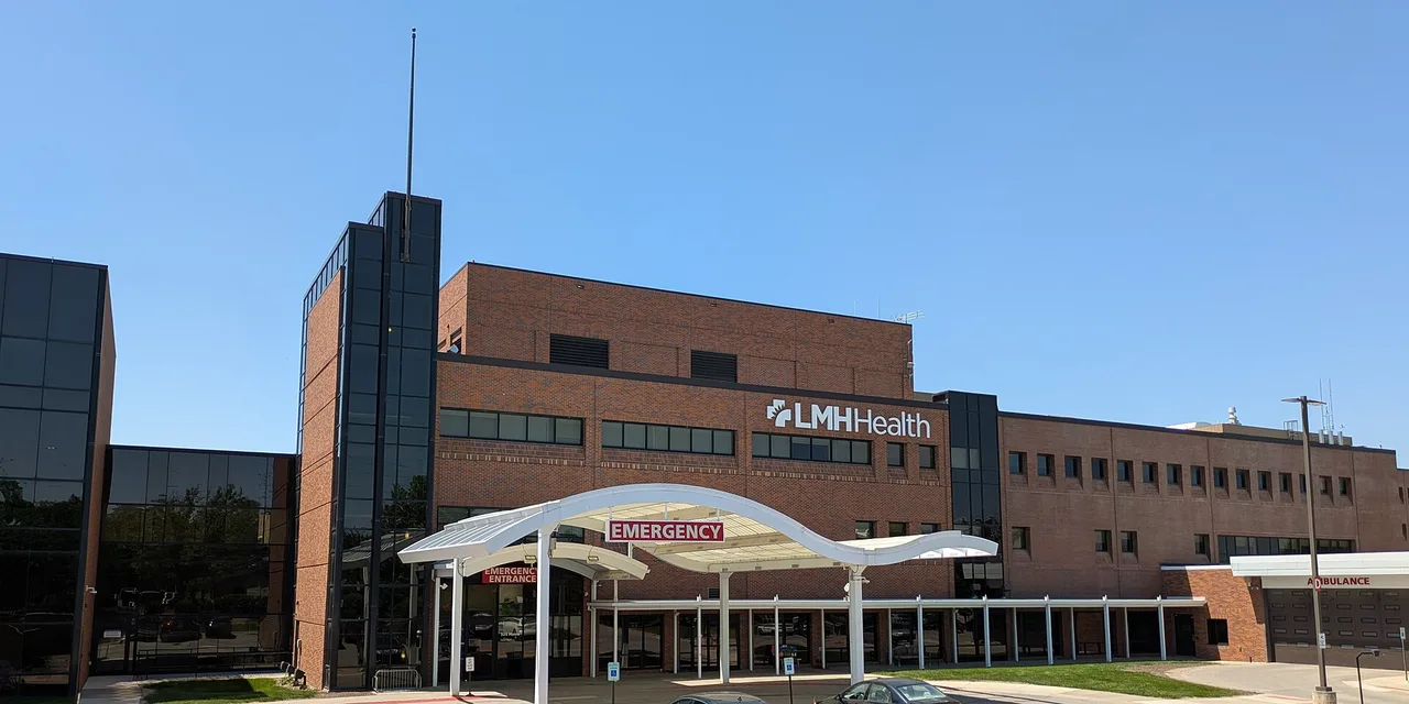 The emergency department entrance of Lawrence Memorial Hospital with an illuminated Emergency sign