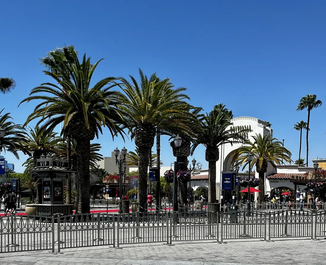 Visitors walking through the main entrance courtyard at Universal Studios Hollywood