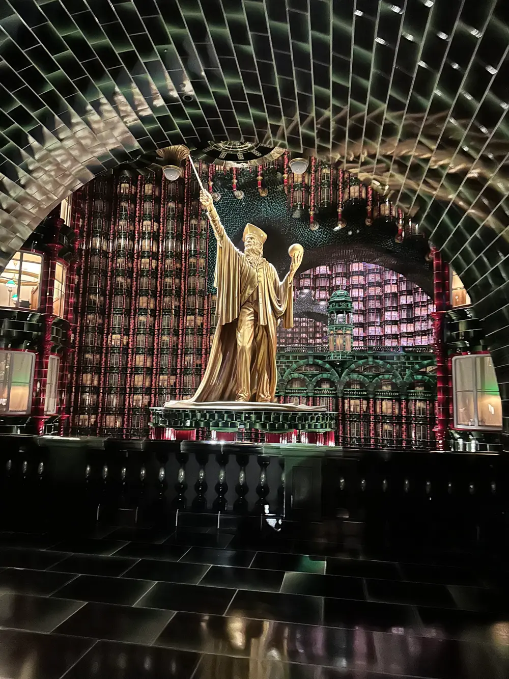 The gilded atrium statue inside the Ministry of Magic land at Universal Epic Universe
