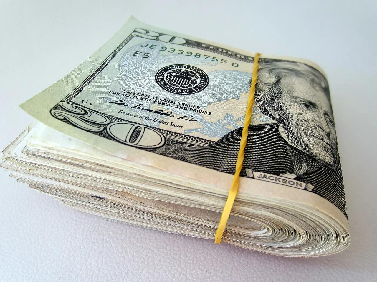 A stack of United States twenty dollar bills
