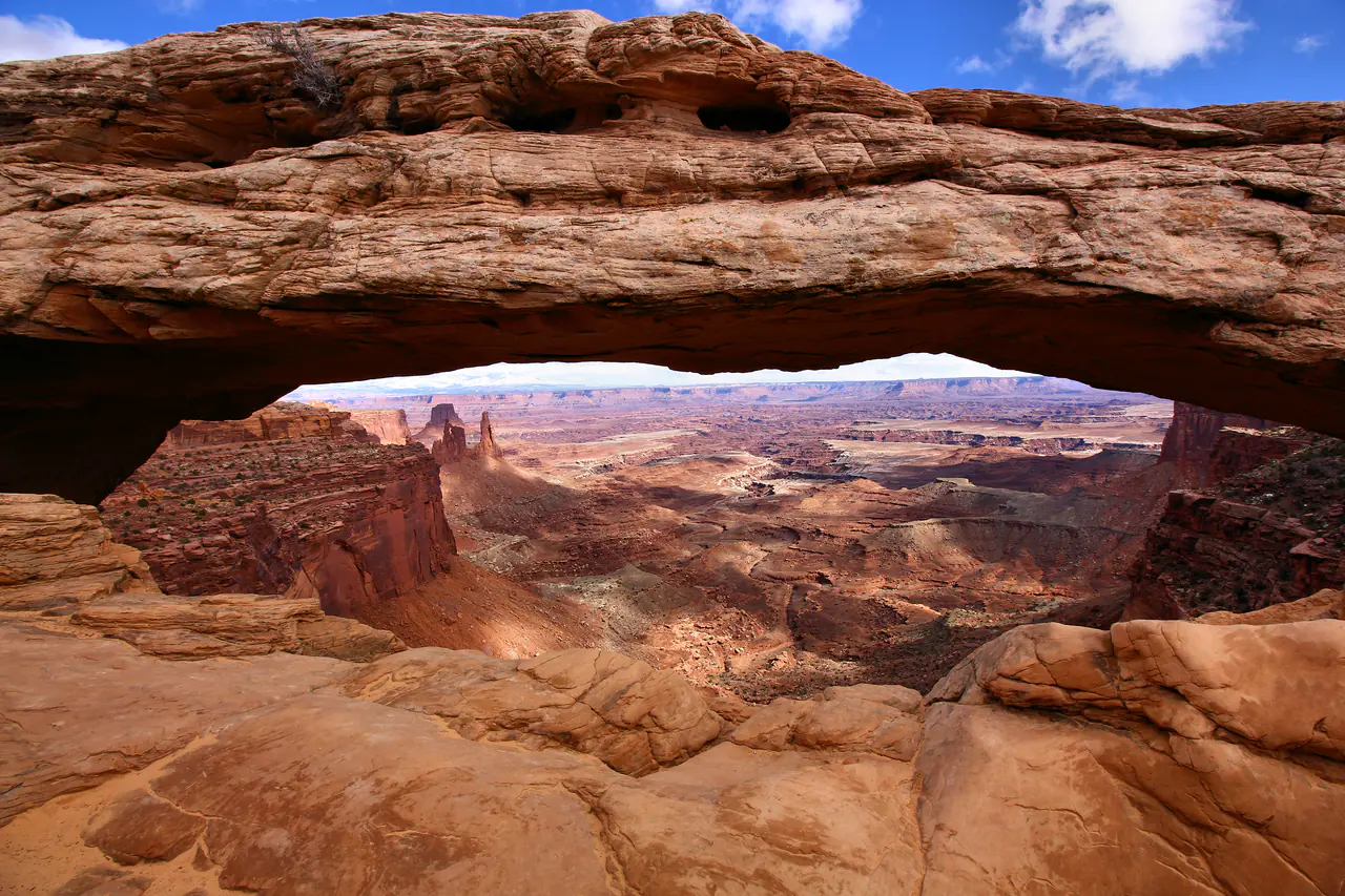 Sunrise light under Mesa Arch framing the canyon country of Island in the Sky, Canyonlands National Park