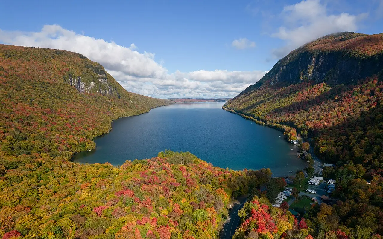 Lake Willoughby flanked by steep cliffs in peak fall color