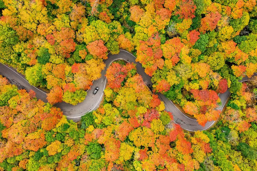 Fall foliage on the cliff-lined Smugglers Notch pass in Vermont