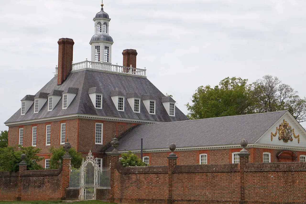 The Governor's Palace at Colonial Williamsburg behind its brick wall and iron gate