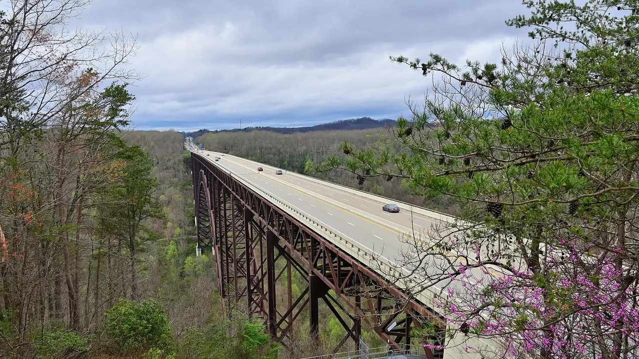 New River Gorge Bridge spanning the forested gorge under clear April sky in West Virginia