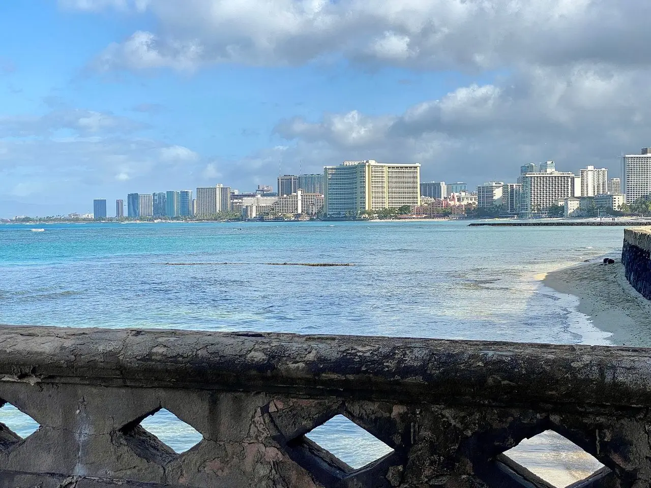 View along Waikiki beach and hotel towers from the Natatorium at the Diamond Head end