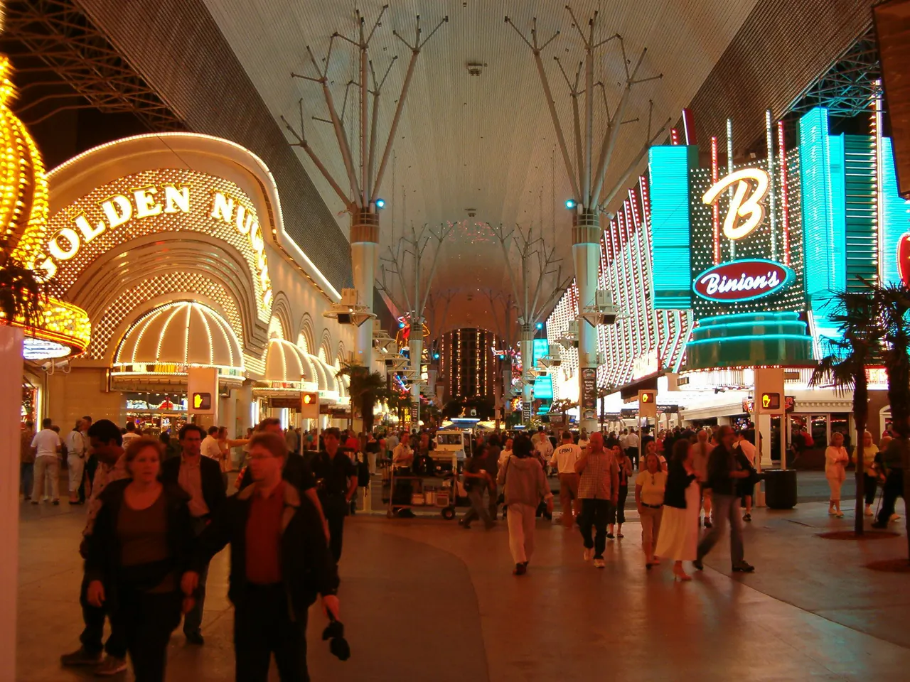 Neon signs of the Golden Nugget and other casinos glowing over Fremont Street in downtown Las Vegas