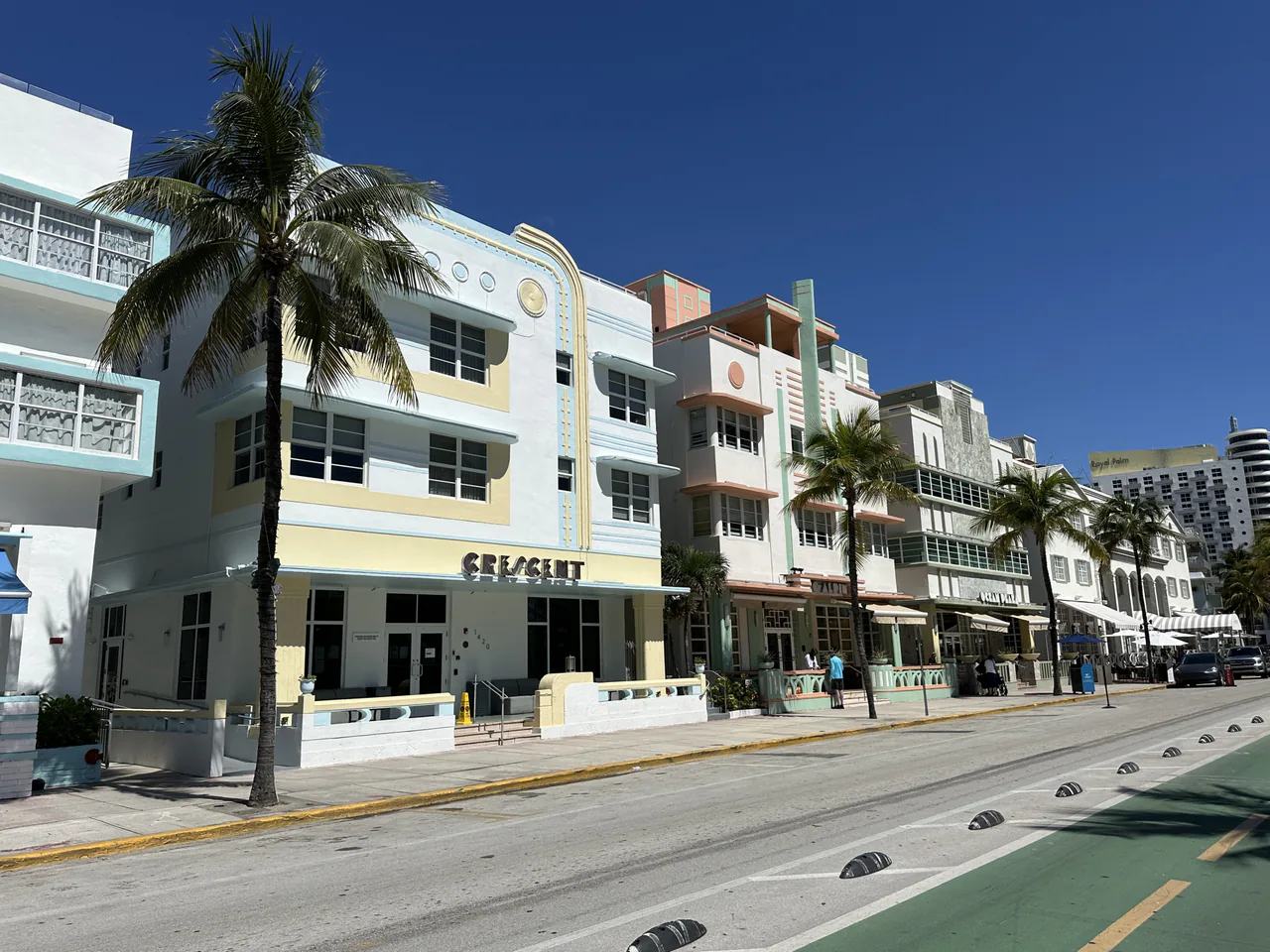 A row of pastel Art Deco hotels along Ocean Drive in South Beach at dusk