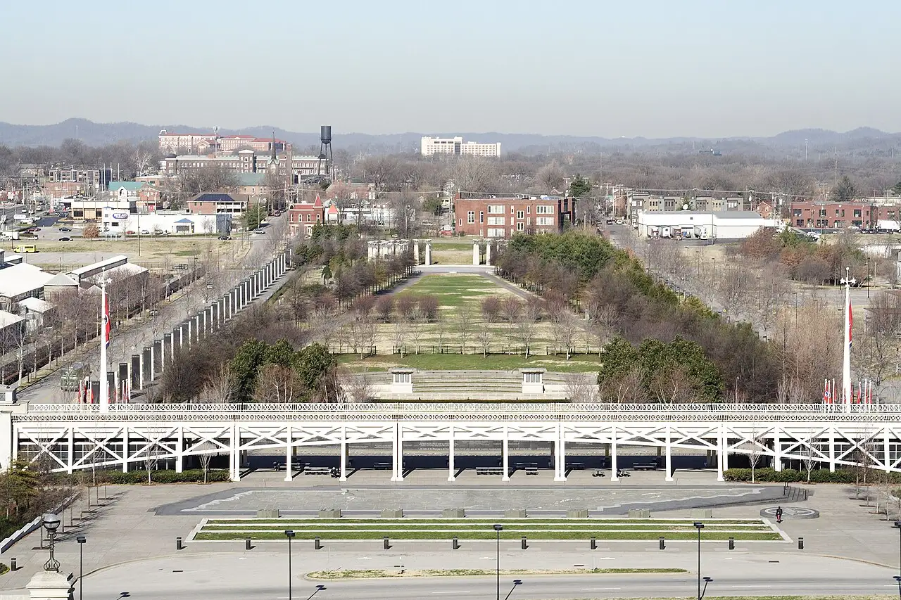 Bicentennial Capitol Mall State Park with Germantown's brick buildings visible along the tree line beyond it