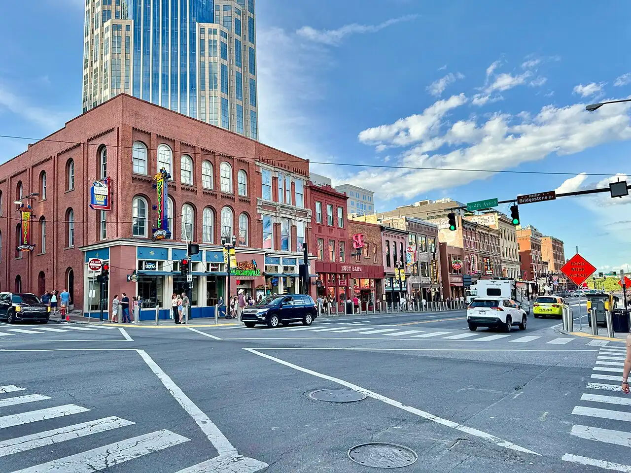 A honky-tonk corner on Lower Broadway in downtown Nashville with the AT&T Building behind