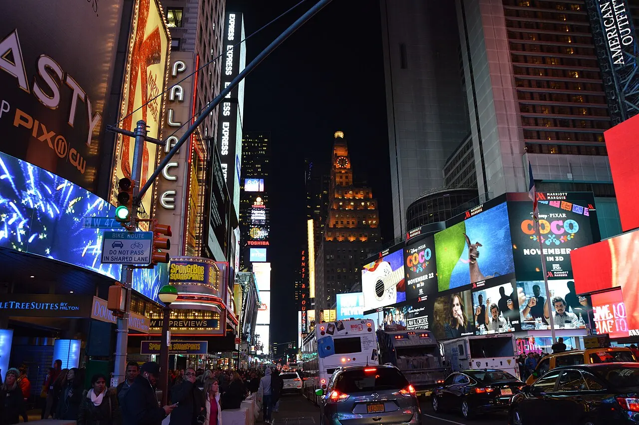 Crowds, traffic and lit billboards on Seventh Avenue at West 47th Street in Times Square at night