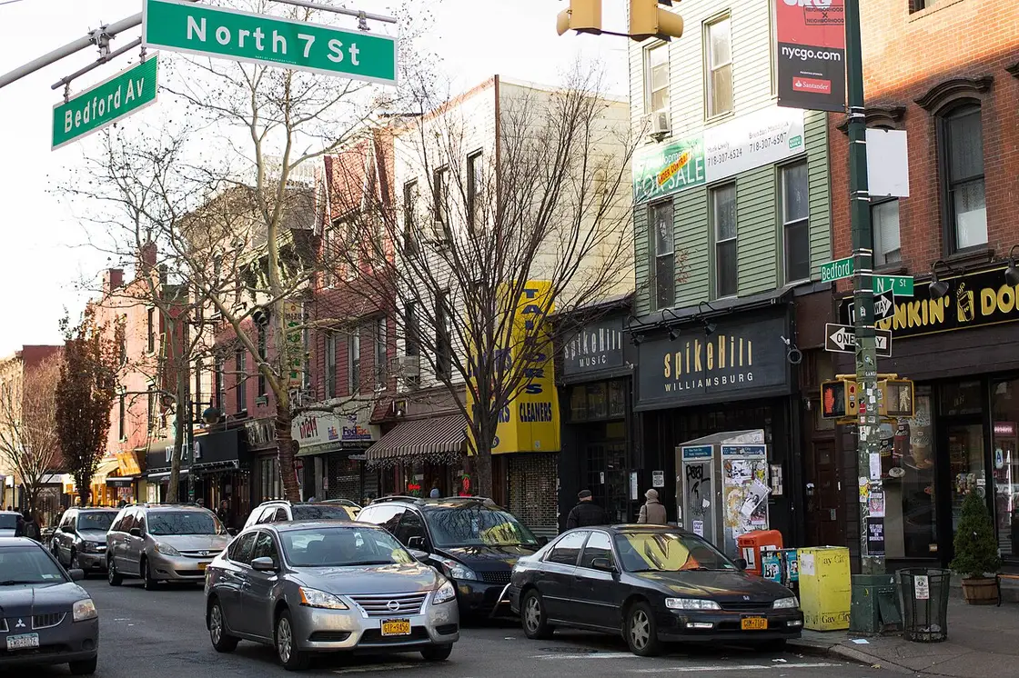 Shops, cafes and street signs at Bedford Avenue and North 7th Street in Williamsburg, Brooklyn