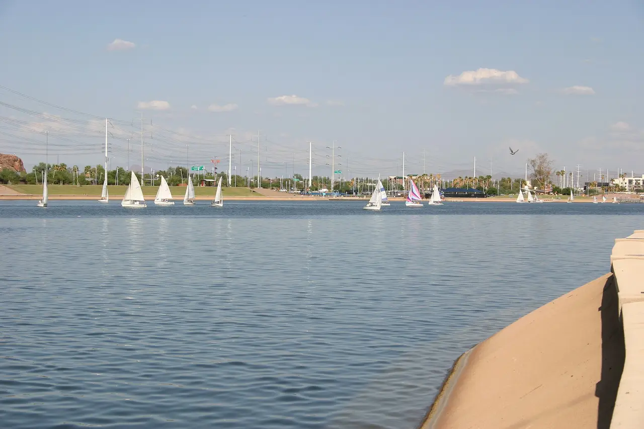 Sailboats on Tempe Town Lake with downtown Tempe buildings along the far shore