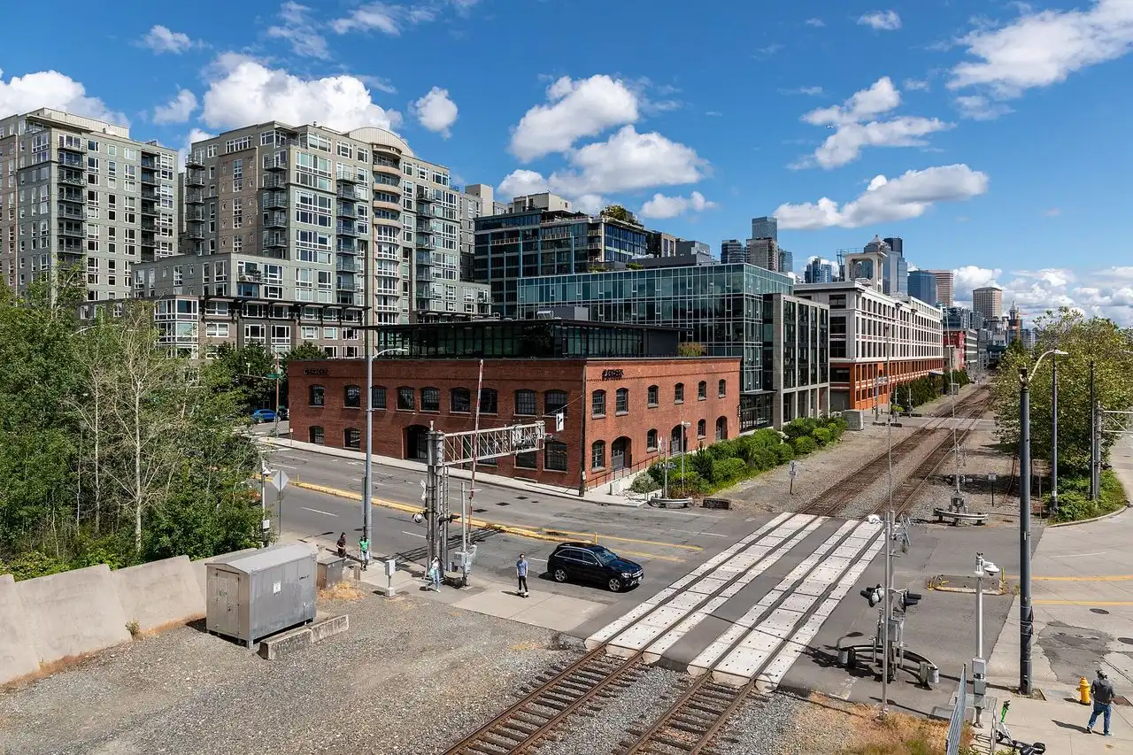 Condo towers and brick warehouses at the north end of Belltown in Seattle with the rail line in the foreground