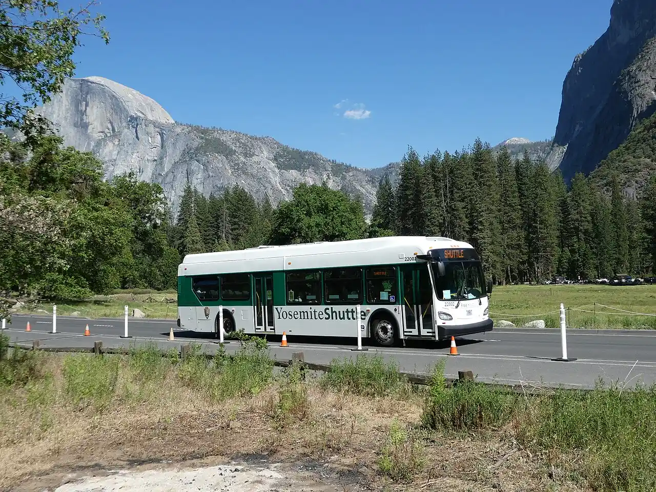 A free Yosemite Valley shuttle bus with Half Dome visible in the background